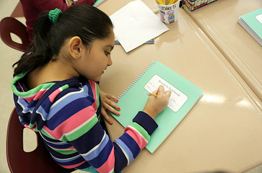 Student writing in Reader's Notebook